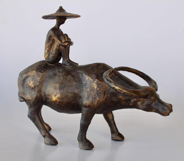 Man Sitting On Buffalo
